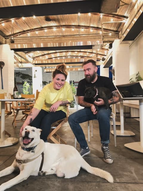 Jonny and Tiffany seated with their two dogs